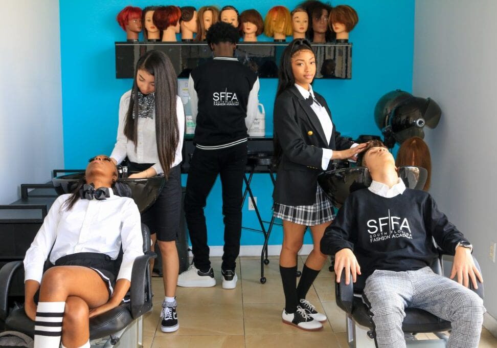 A group of people sitting in chairs with hair cut.