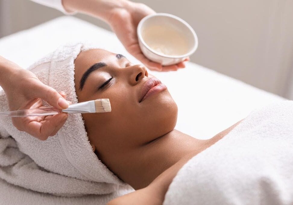 A woman getting her face washed with a cream